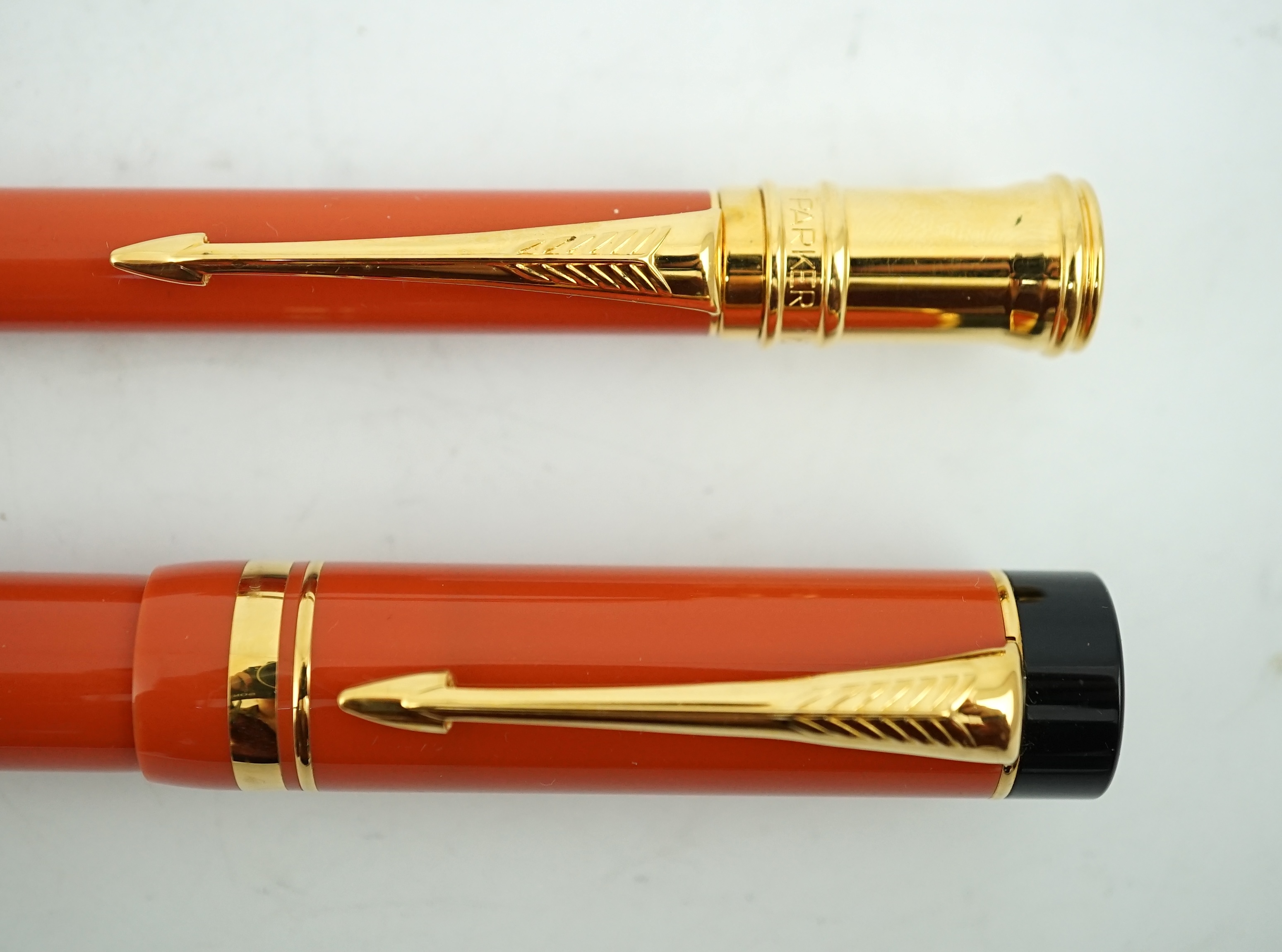 A Parker Duofold orange centennial fountain pen and pencil set, in wooden case